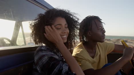 couple relaxing on a pickup truck at beach 4k