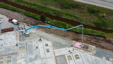 concrete boom pump mounted on a truck pouring concrete mix at precast fabrication site