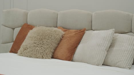 cozy bedroom detail with stylish textured pillows