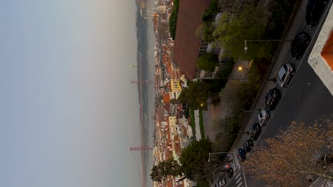 vertical dusk timelapse of 25 de abril bridge with traffic, tagus river, lisbon