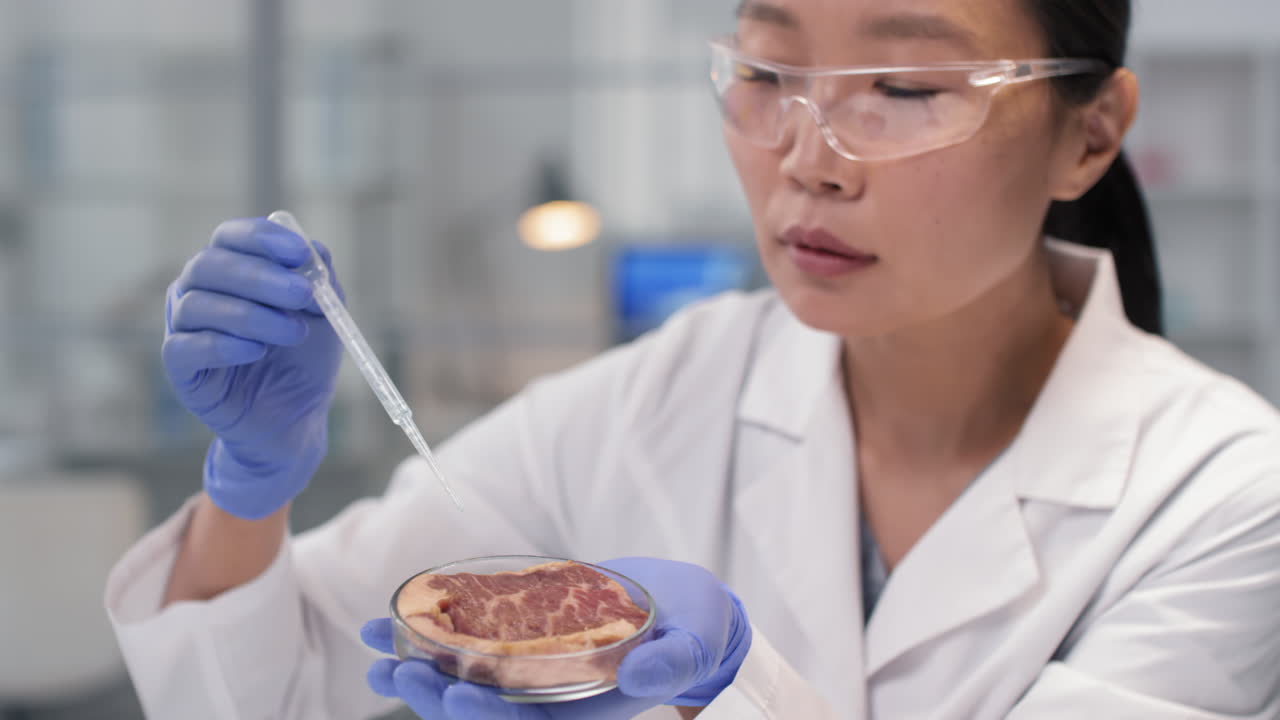 Scientist Examining a Sample of Meat in a Lab