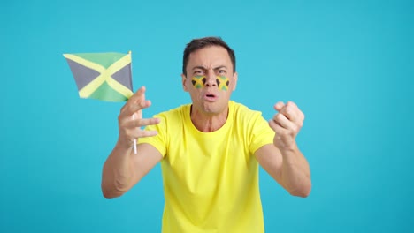 man cheering for jamaica, angry with the decision of referee