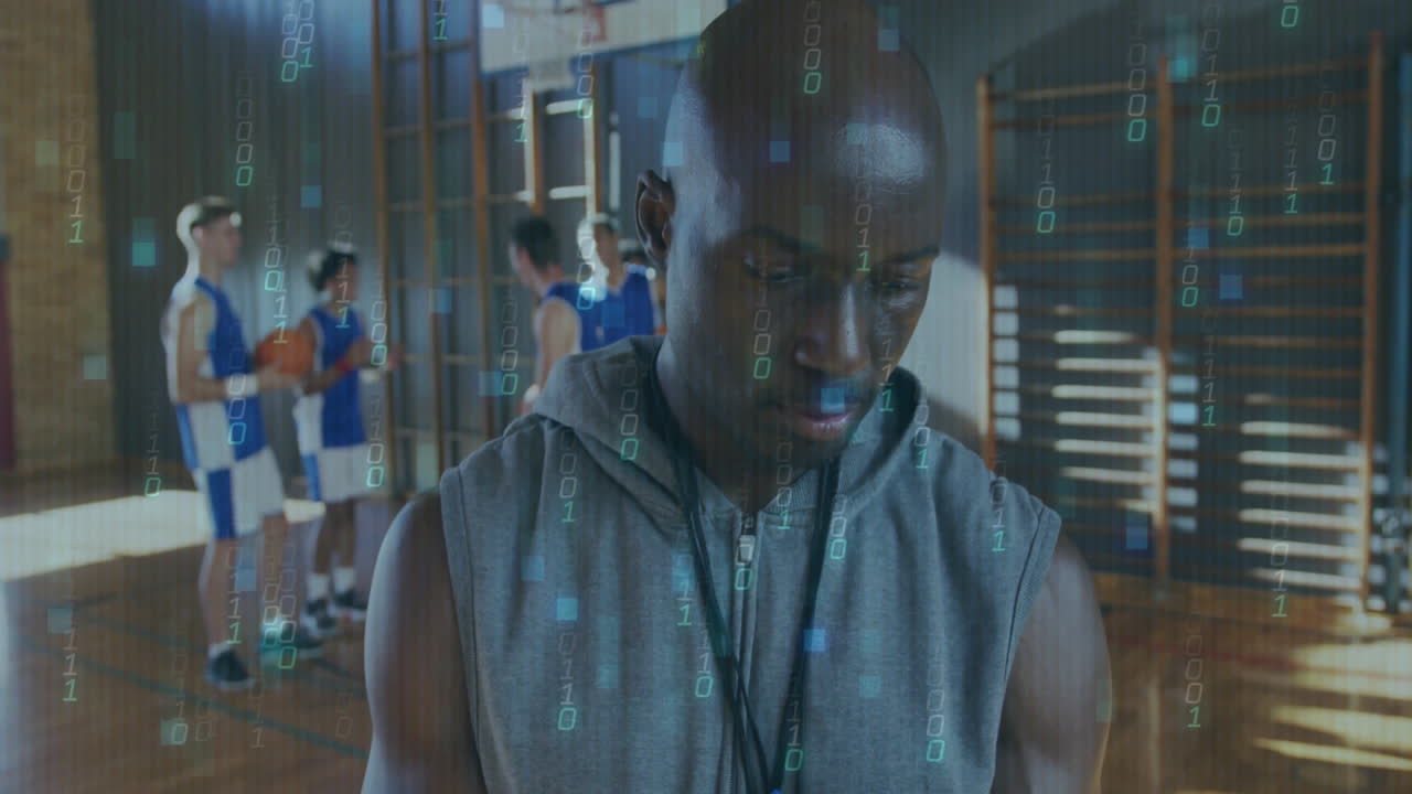 Coach in gym with binary code animation over basketball players practicing
