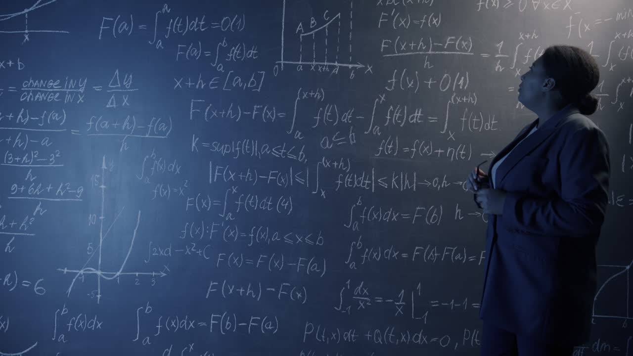 Woman Lecturer Explaining Mathematics on a Chalkboard