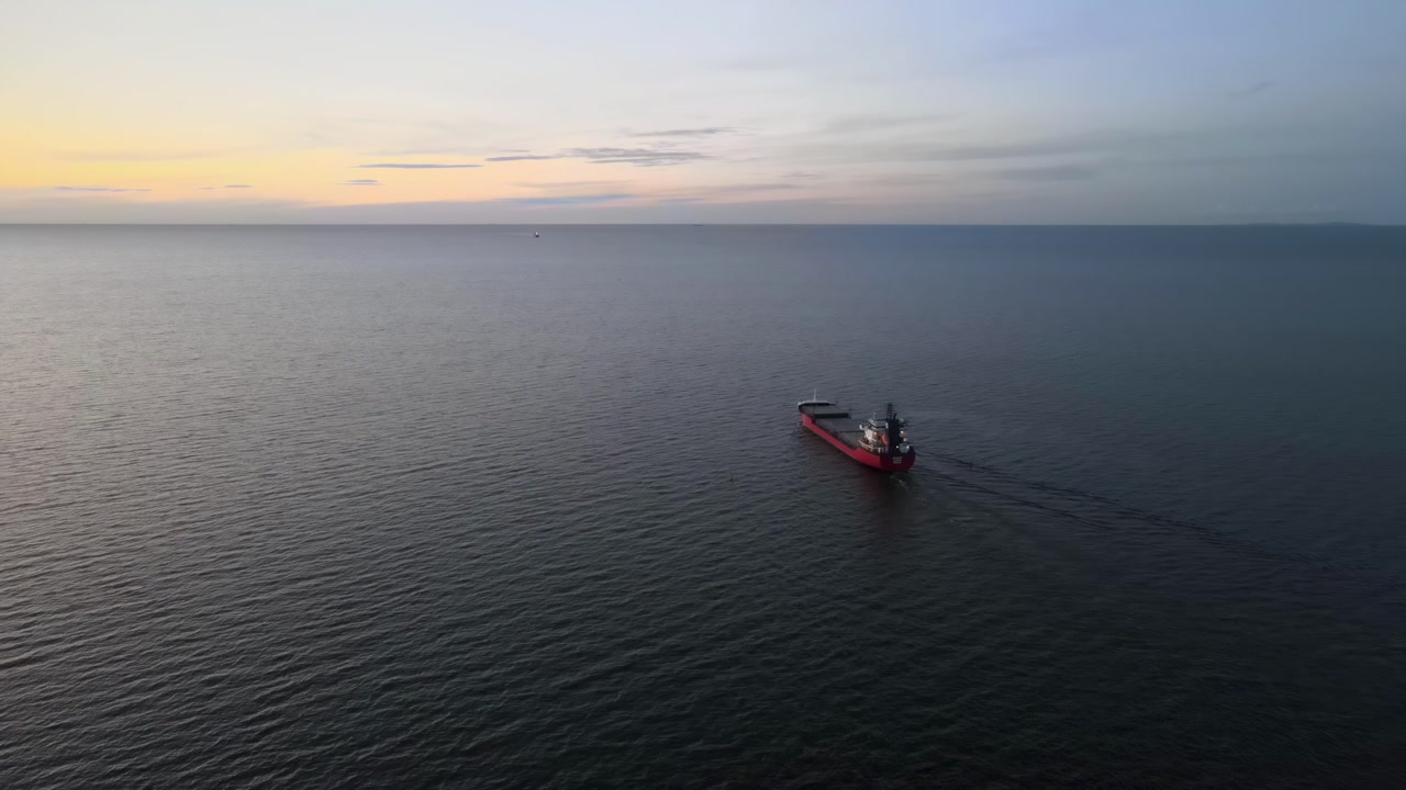 Commercial Cargo Vessel Sailing Away on Calm Sea