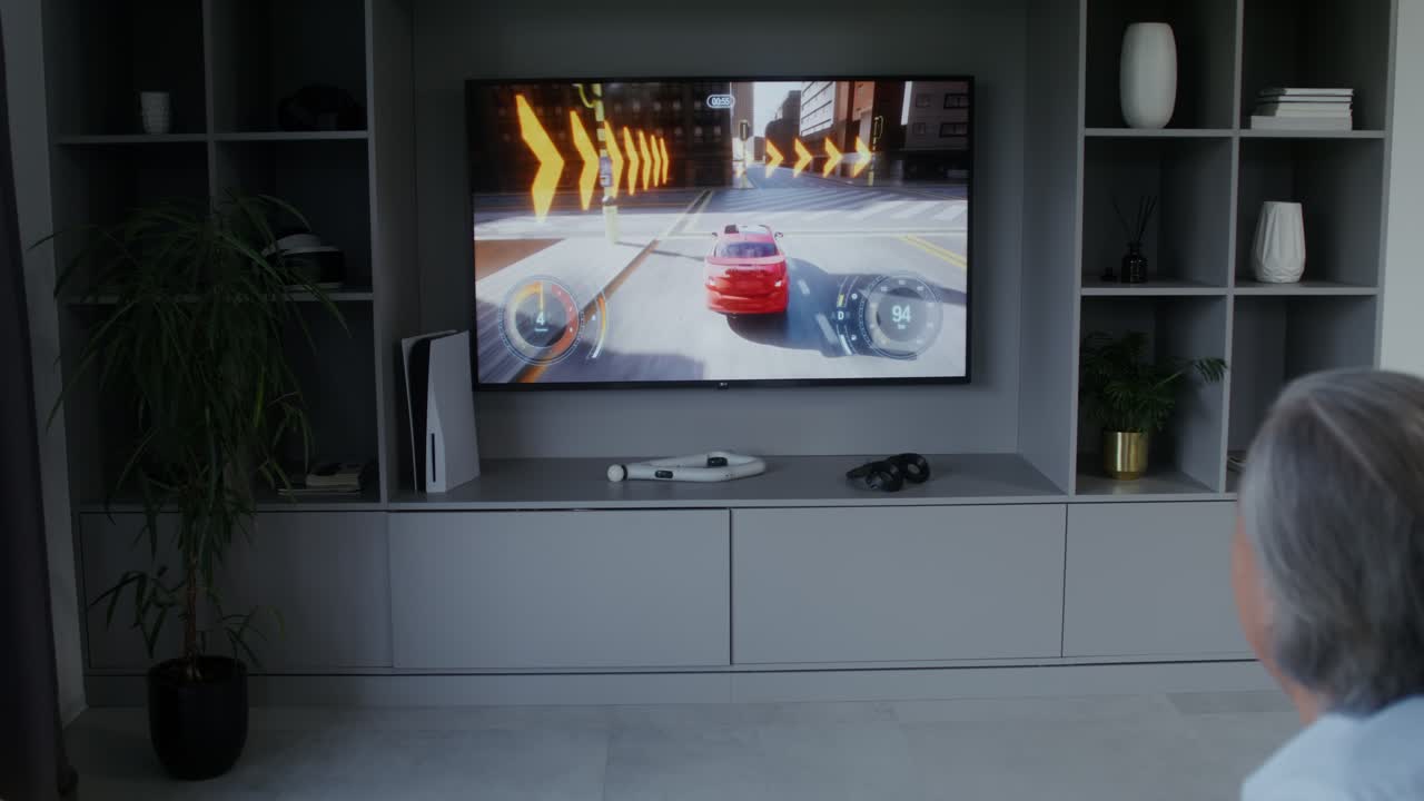 A person playing a car racing video game on a TV