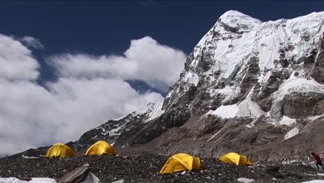 Climber-walking-to-and-entering-tent-under-Pumori