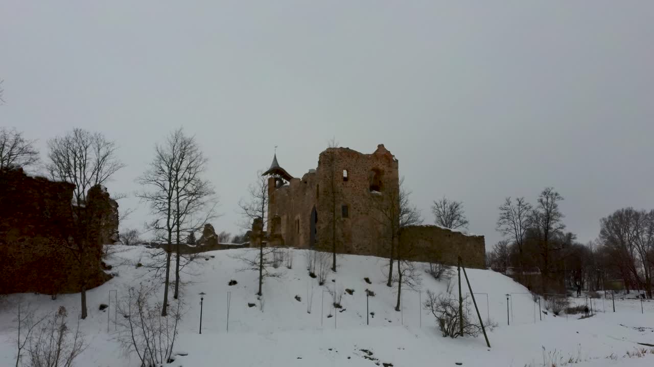 Ruins of Ancient Livonian Order's Stone Medieval Castle Latvia Aerial Drone Top Shot From Above . Restored Castle Capella at Winter in Dobele City. 4K Resolution. Camera Moves Forward