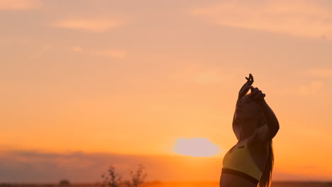 Beach-volleyball-match-girls-hit-the-ball-in-slow-motion-at-sunset-on-the-sand