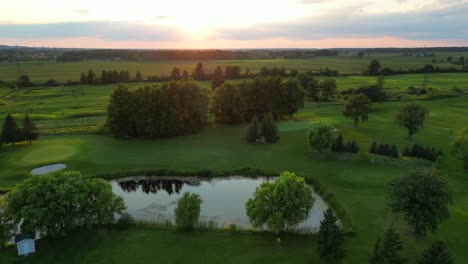 beautiful golf course in countryside at golden sunset