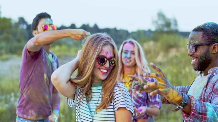 Mixed Races Joyful Young People In Colorful Paints Dancing Together And Celebrating Holi Festival Outside