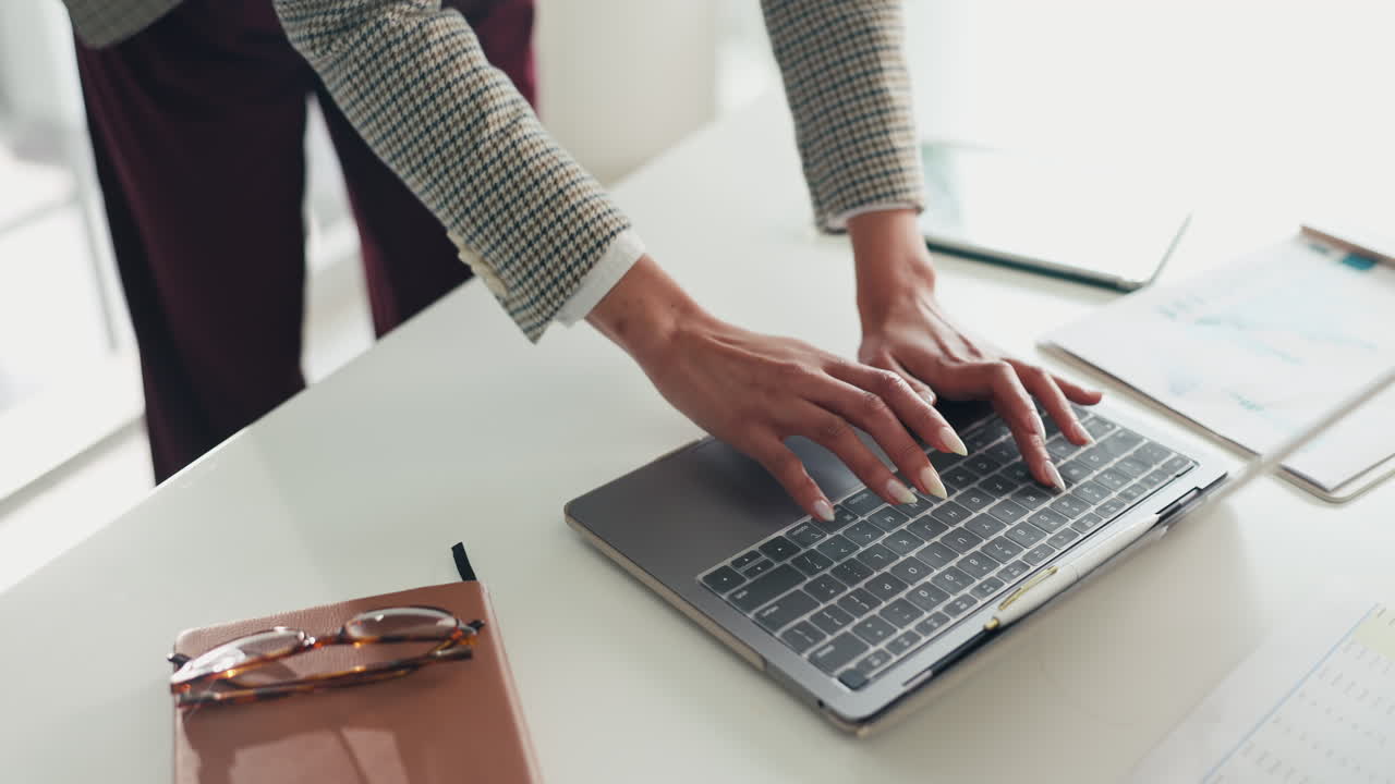 Woman working on laptop at her desk