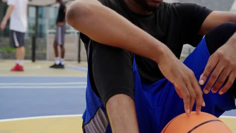 basketball player sitting in basketball court 4k