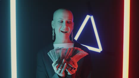 Woman holding money in neon light