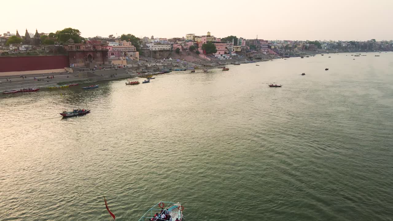Panoramic aerial view of Banaras, highlighting the Ganga River flowing past its iconic ghats and temples.