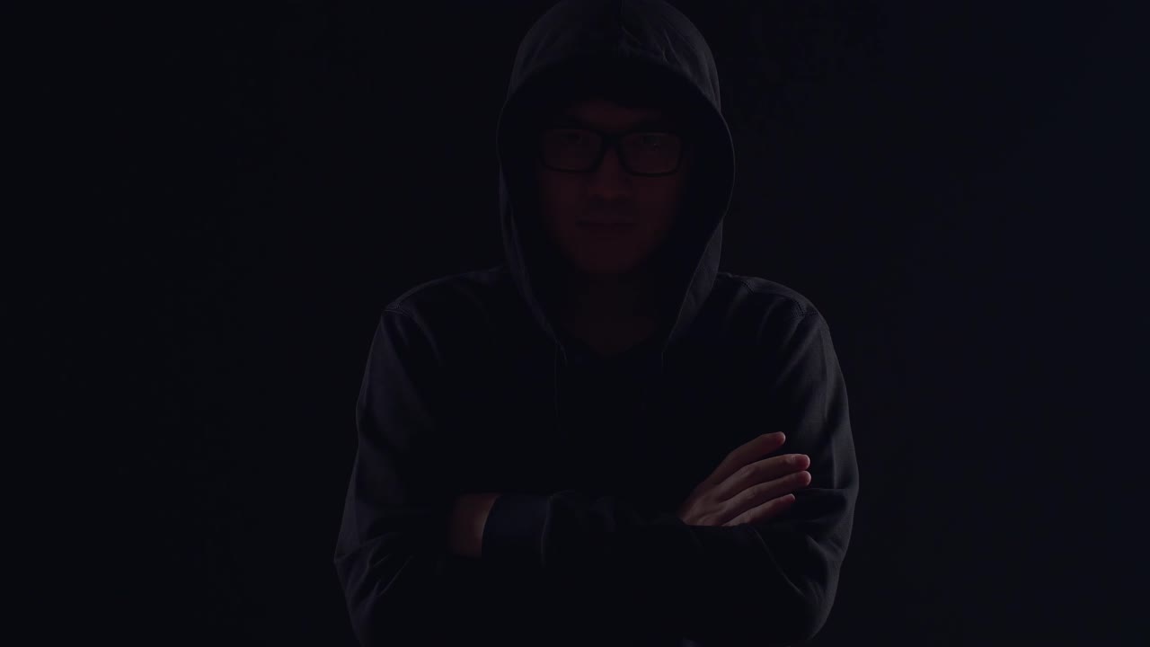 Asian Hacker Pose On Black Background