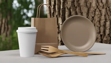 eco-friendly disposable food packaging and cutlery in a natural setting