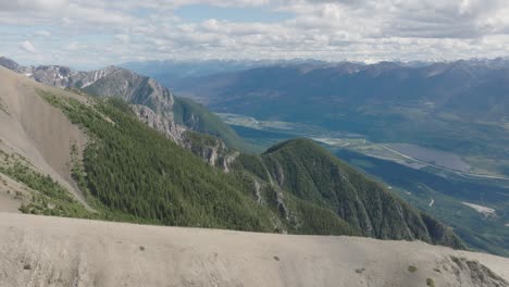 flying towards beaverhead peak overlooking columbia river and columbia river valley in british columbia, canada. aerial shot
