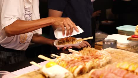 chef prepares and serves japanese rice rolls