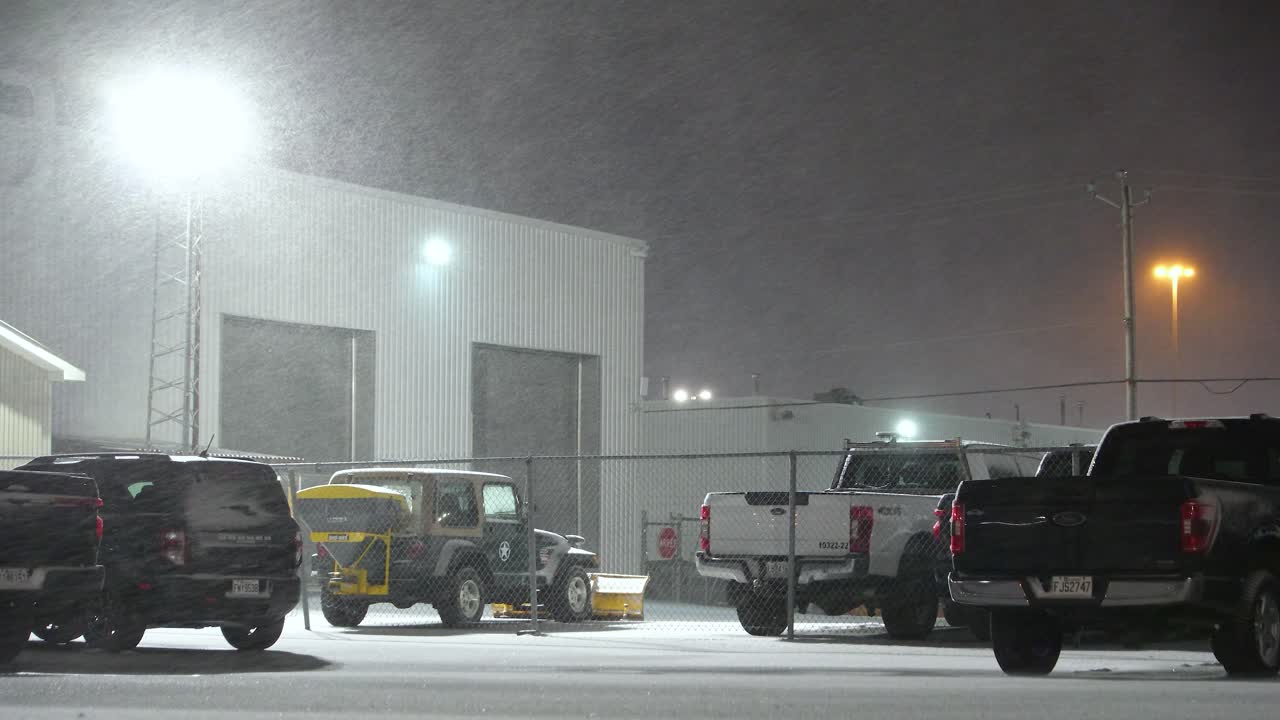 Static shot of parking lot during a heavy snowstorm at night time Quebec Canada