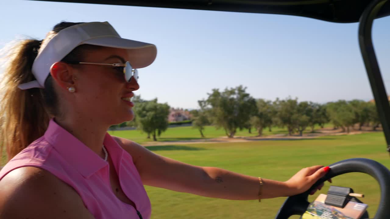 Woman driving a golf cart on a golf course