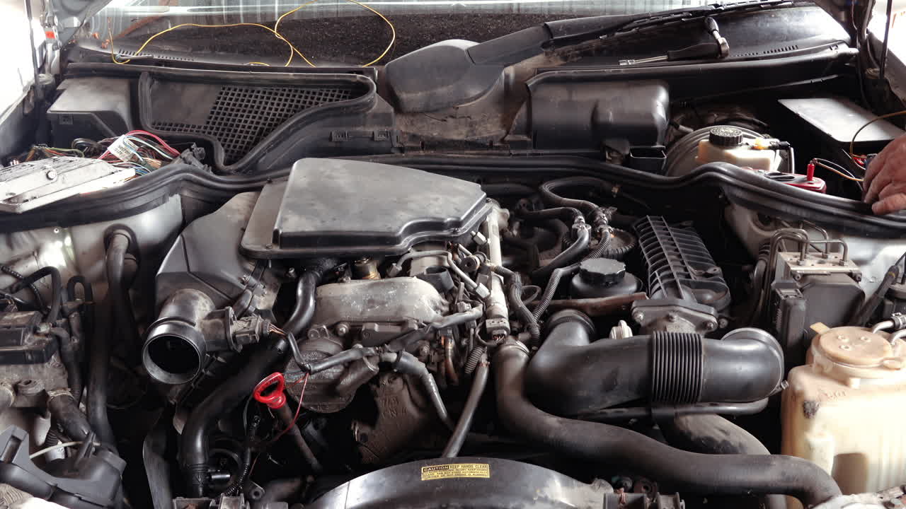 Man working on the engine bay of a car
