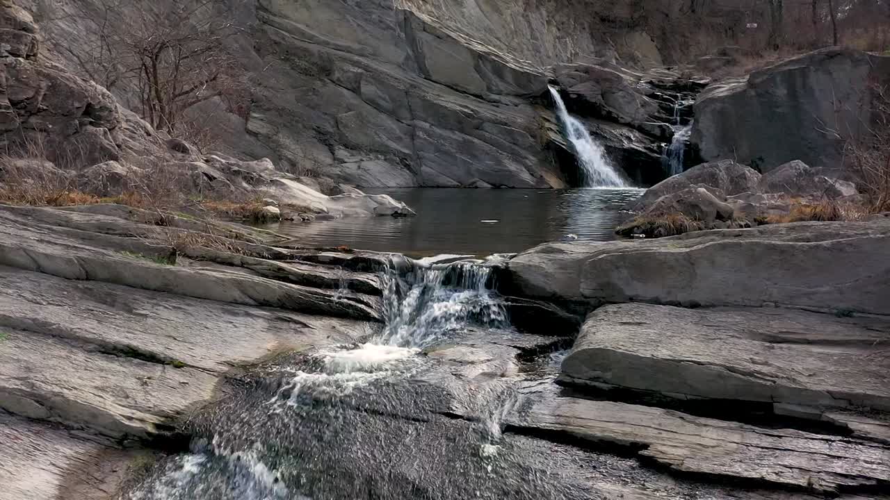 낮에는 폭포 근처에서 물 위를 가로지르는 드론 비행