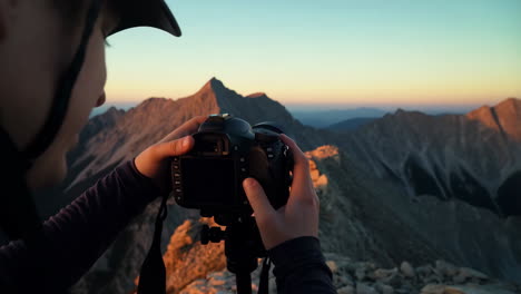 photographer capturing a mountain landscape at golden hour