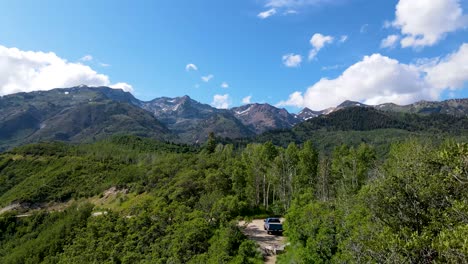 a truck parked along a rugged mountain trail in the wilderness