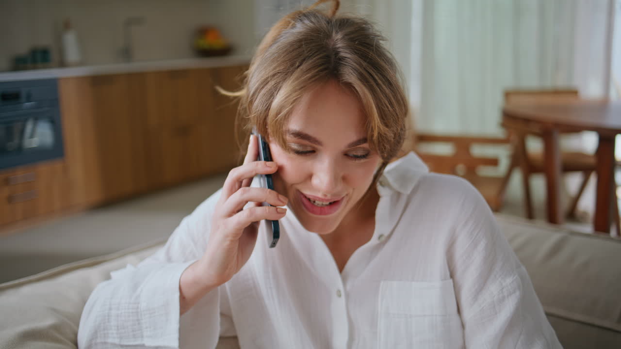 Resting lady answering call sitting home apartment sofa closeup. Smiling woman