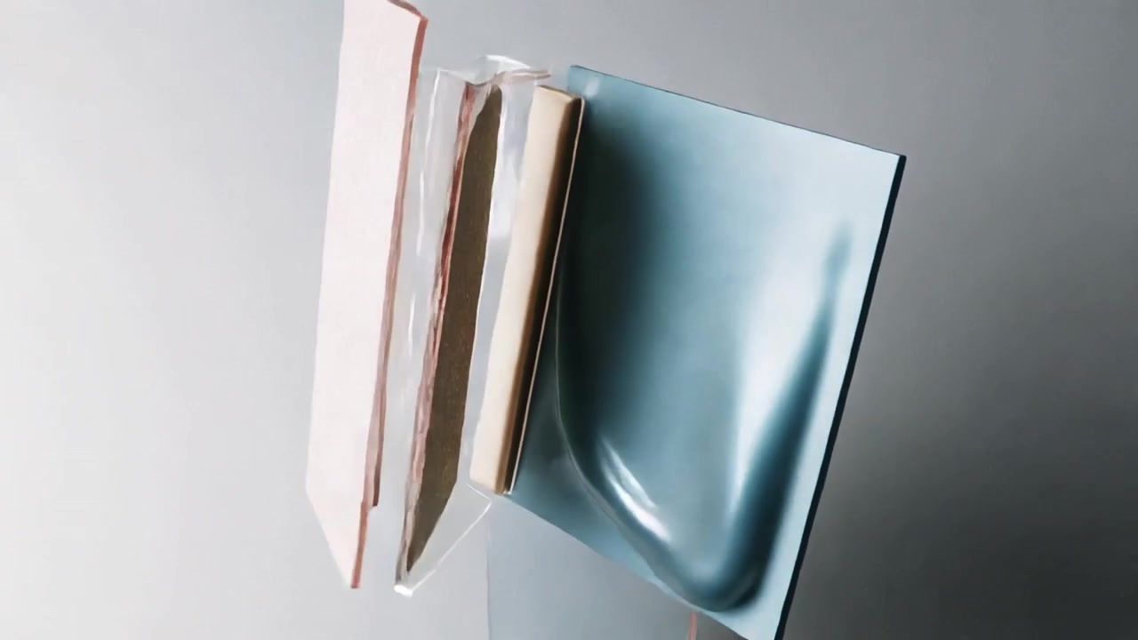 Rotating motor-driven layered panels at studio, gels pooling, revealing beige insert and gold strip