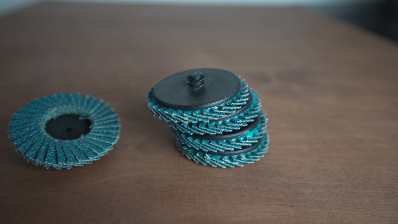 Detail of a grinding wheels laid on the wooden table