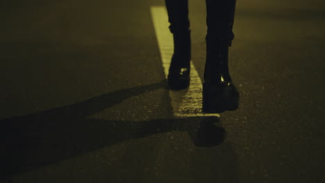 Woman-walking-legs-night-alone-on-city-road.-Girl-going-legs-in-shoes.