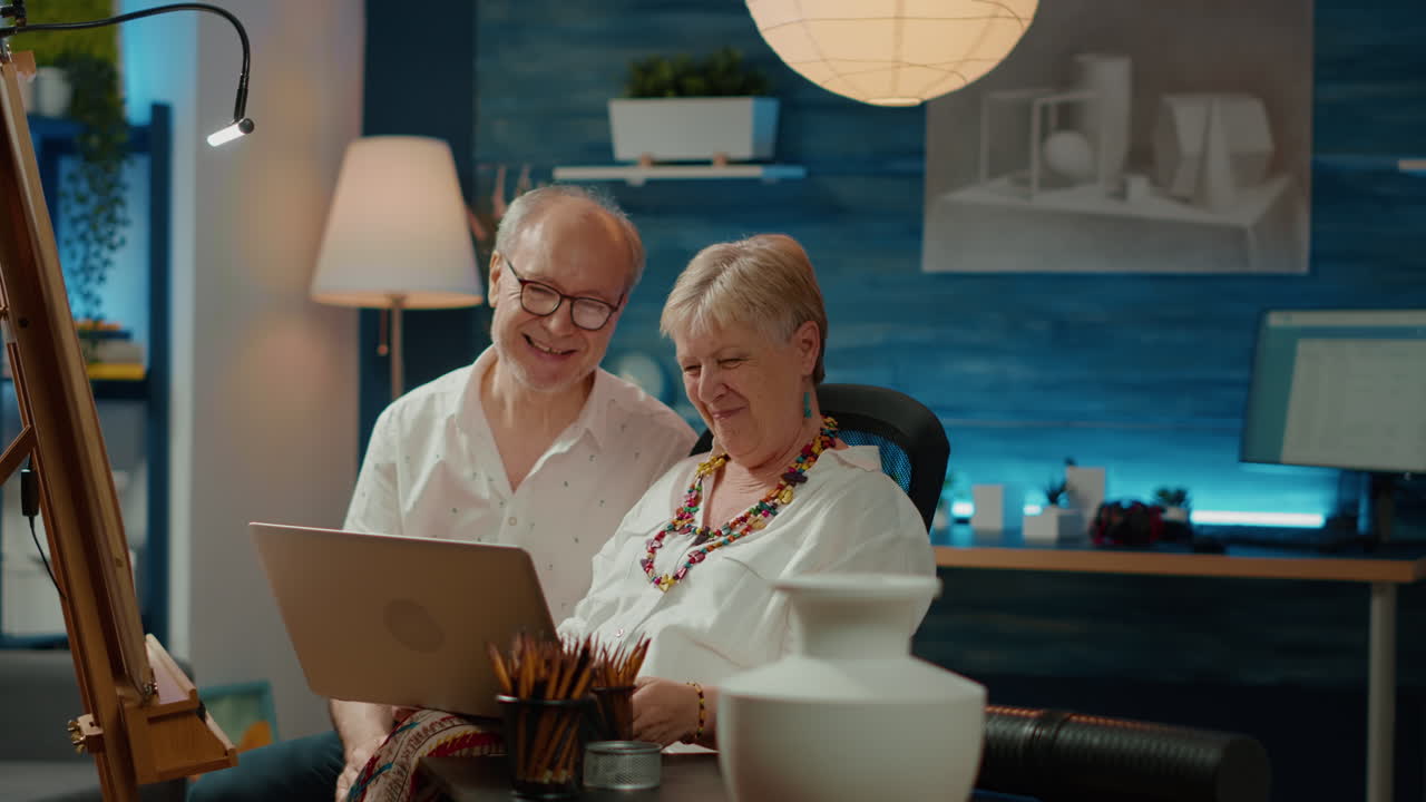 Team of old people finding drawing inspiration on laptop