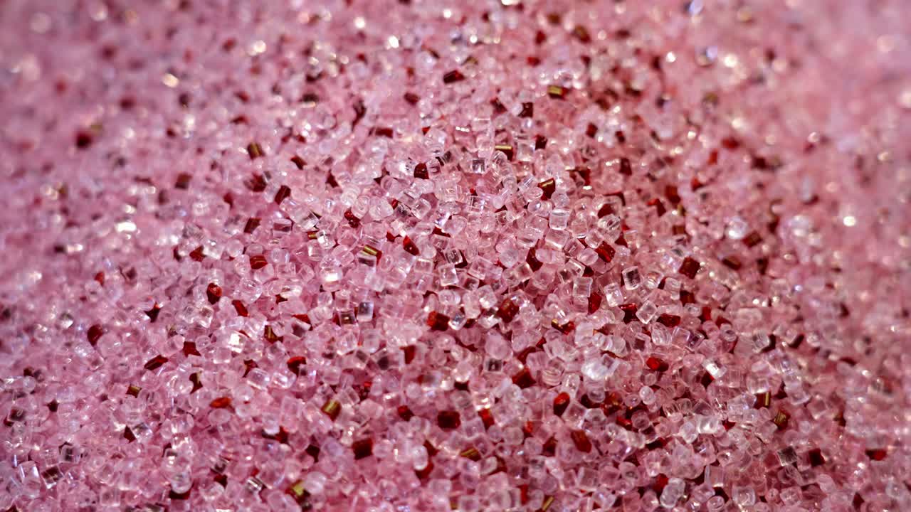 Close-up of pink and red polymer granules