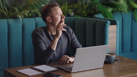 thoughtful serious young man student writer sit at home office desk with laptop thinking of inspiration search problem solution ideas lost in thoughts concept dreaming looking away