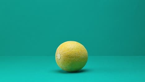 fresh ripe melon rolling and jumping on turquoise background. rotating plate of melon slices. stop motion animation