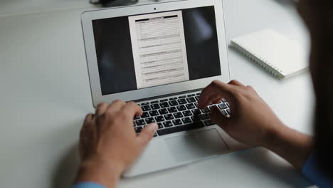 cropped shot of young man filling form on laptop.