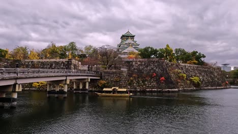 view on castle moat onto the famous osaka castle in japan