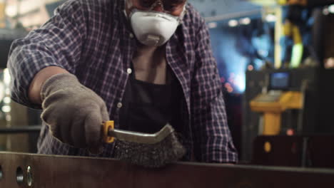 worker sanding down the plank