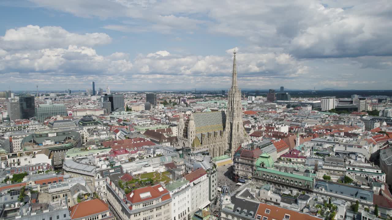 Vienna skyline featuring st. stephen's cathedral on a partly cloudy day, aerial view