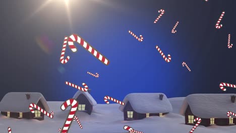 Animation-of-candy-canes-falling-over-houses-in-winter-landscape