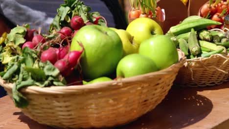 close-up of harvested fruits and vegetable in wicker basket in field