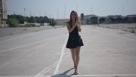 woman walking on an empty urban parking lot