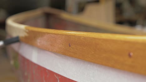 brushing oil onto teak hardwood gunwales