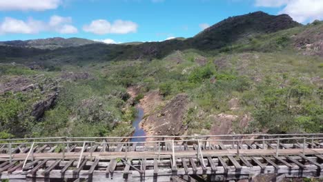 An-old-abandoned-bridge-crosses-the-river-in-the-barren-hills-1