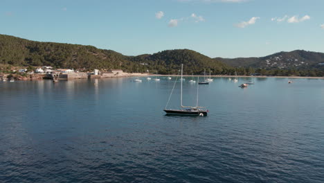 Boats-At-Playa-de-Ses-Salines-In-Ibiza,-Spain---aerial-shot