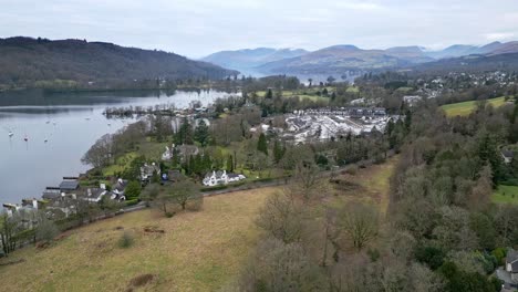 The-port-of-Bowness-in-lake-with-boats-on-a-gloomy-day-in-Windermere,-UK,-aerial