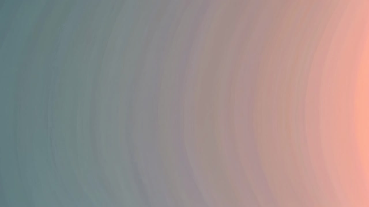 Abstract video background with a gradient blend of teal and peach hues