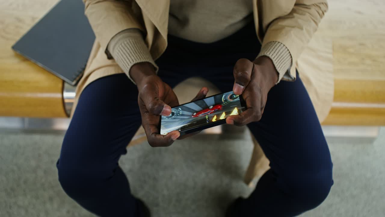 Person playing mobile game on smartphone